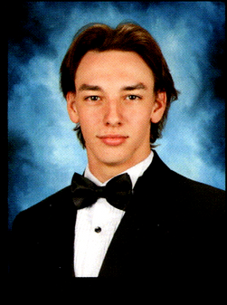 Senior portrait of my nephew Maxwell in a black tuxedo and bow tie, looking confident against a classic blue background