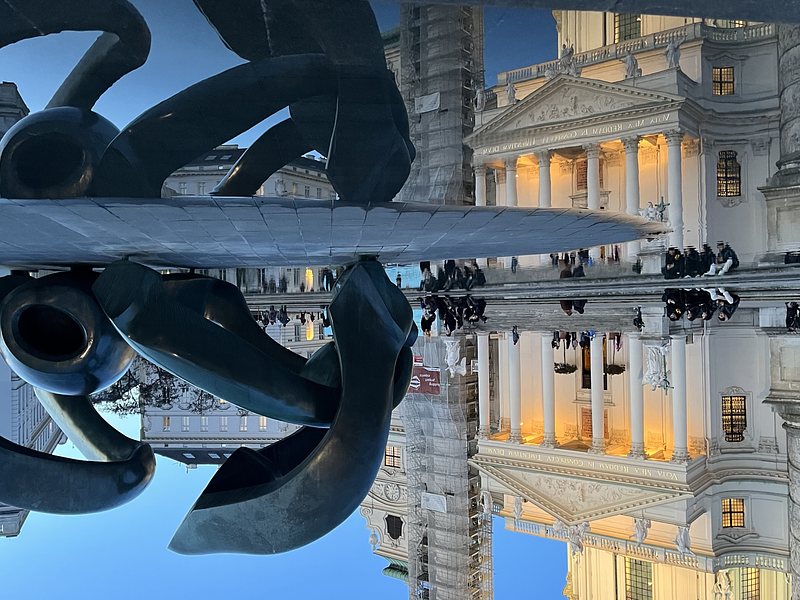 Reflection of a sculpture and the Karlskirche, Vienna (Austria), in a small pond. The Picture is turned upside down.