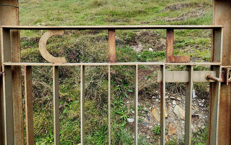 A rusted gate with the letters CIL integrated into the metalwork. CIL stands for the Commission of Irish Lights
