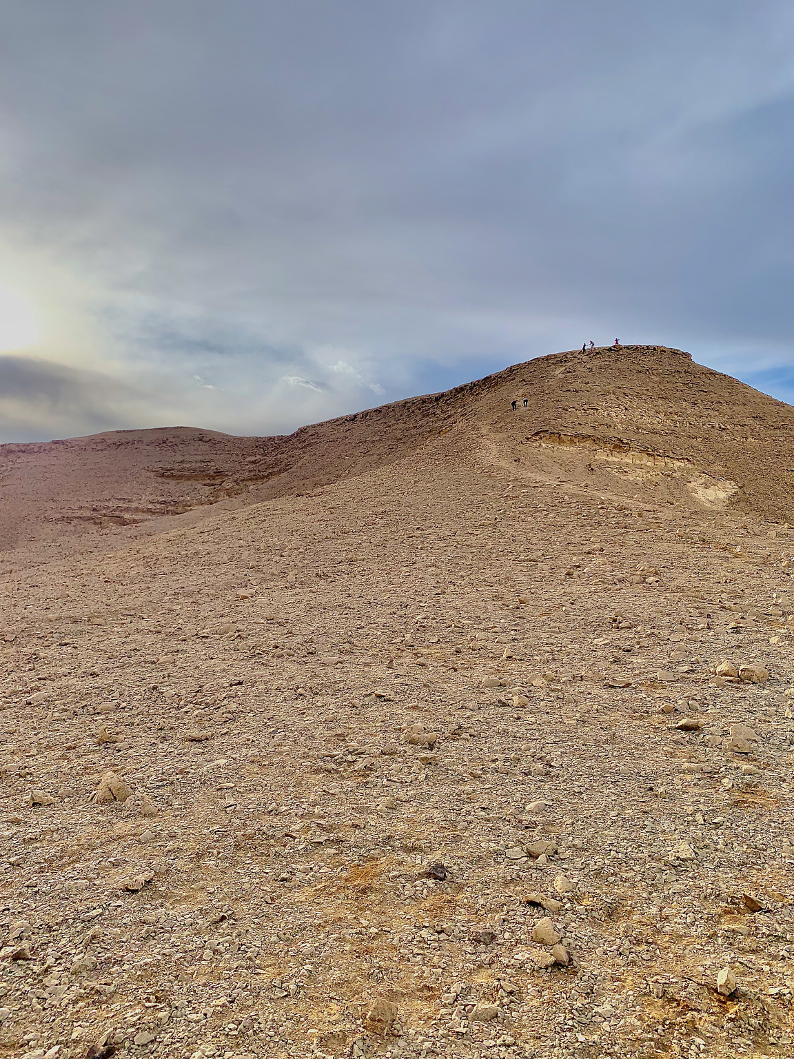 A small hill where people are climbing