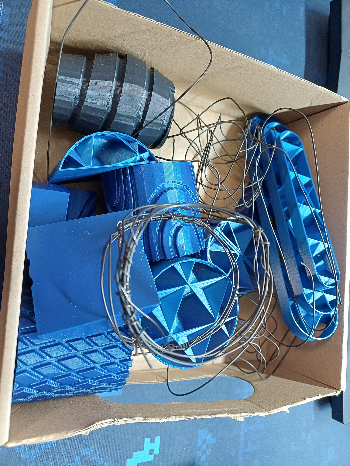 a box full of 3d printed forms and bent wires