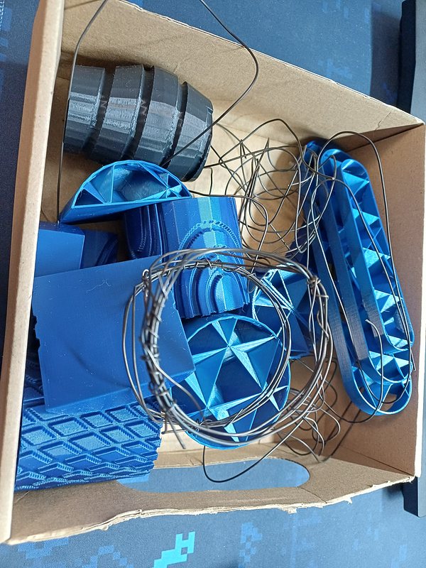 a box full of 3d printed forms and bent wires