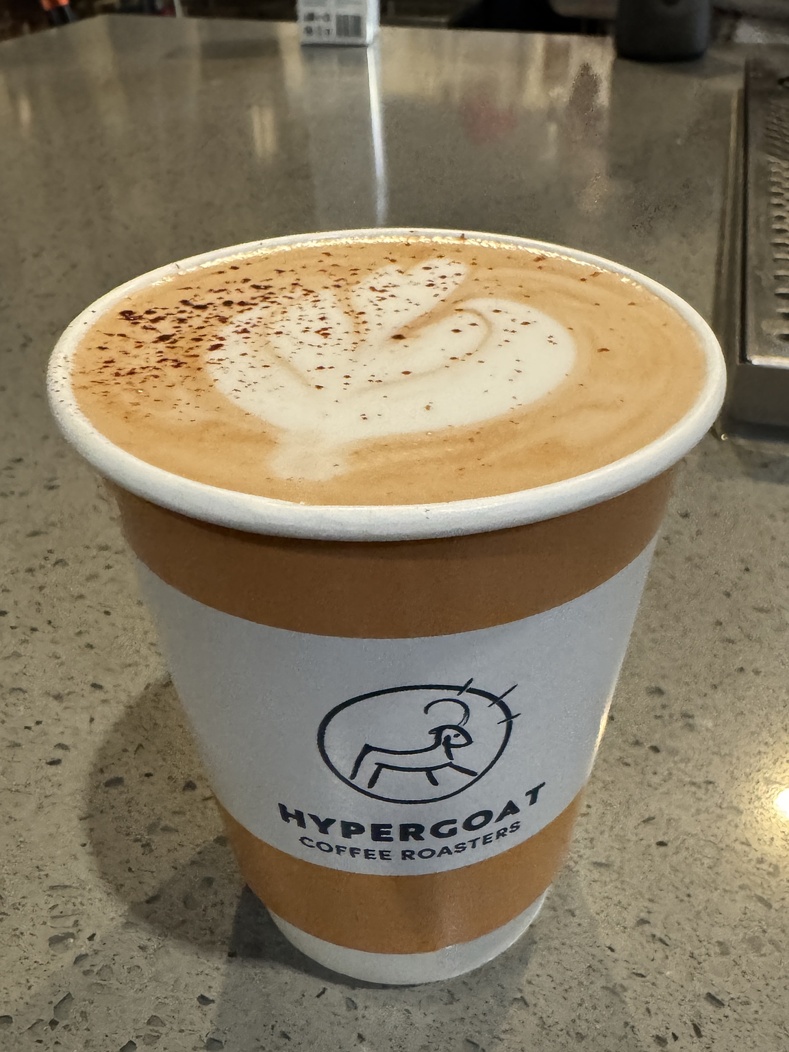 mocha in a disposable cup with the label Hypergoat