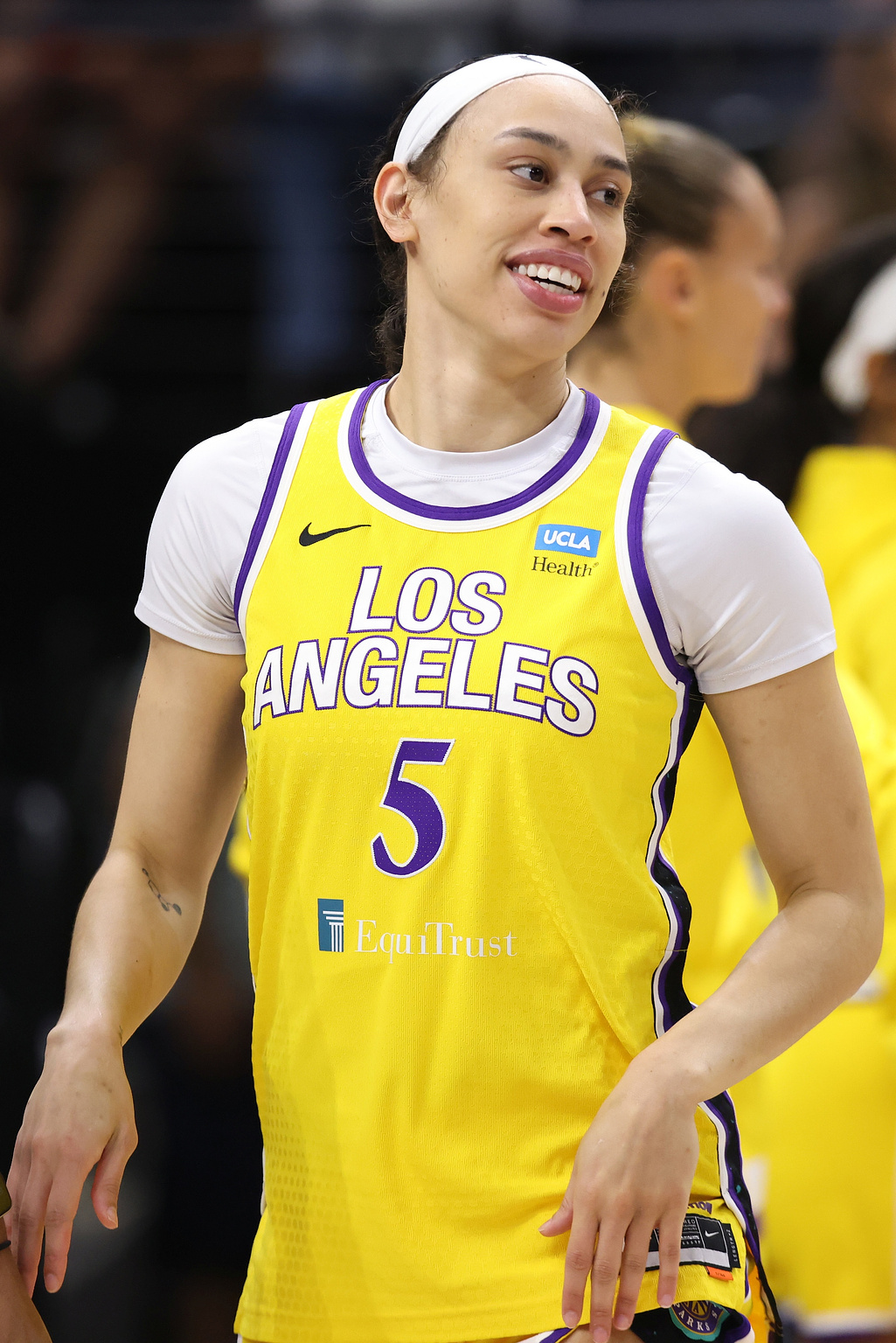 A photograph of Dearica Hamby in her yellow and purple Los Angeles Sparks uniform. 