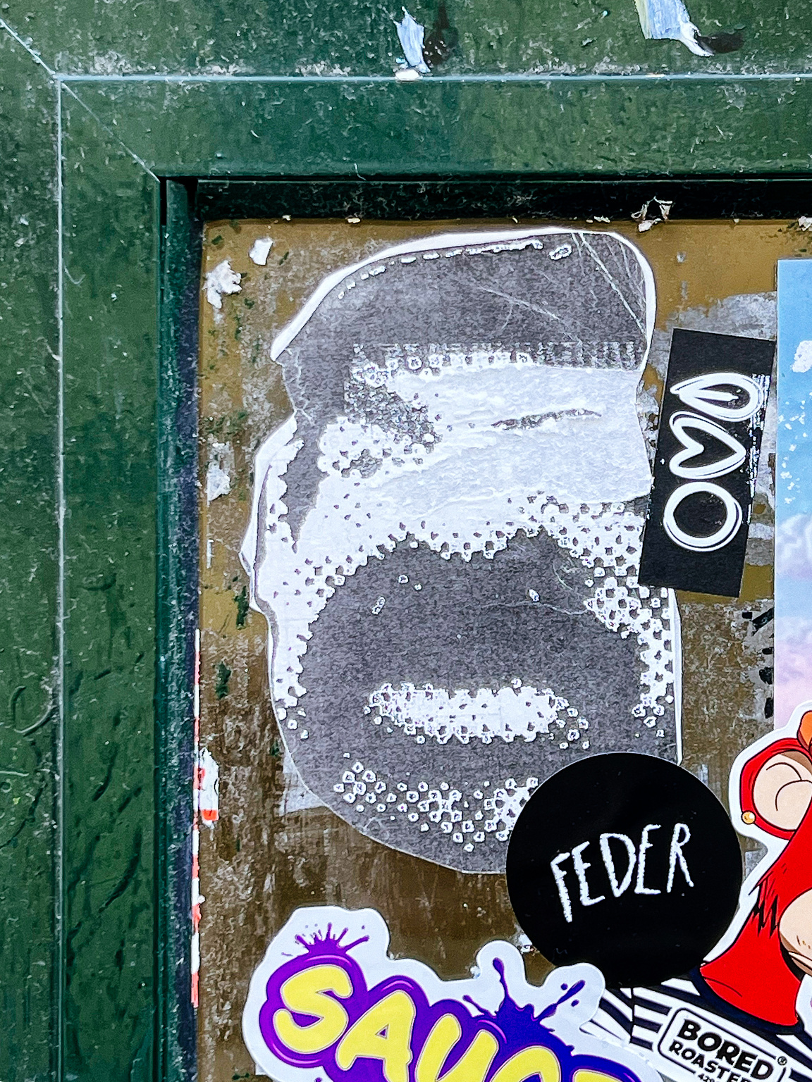 Multiple stickers, one with Saddam's face. 