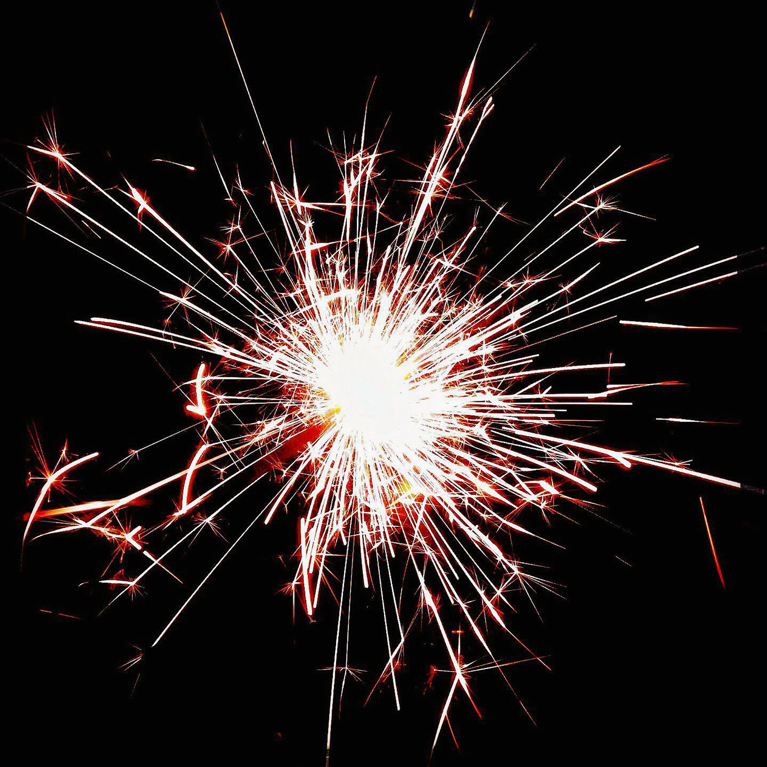 A burst of sparks against a black background.