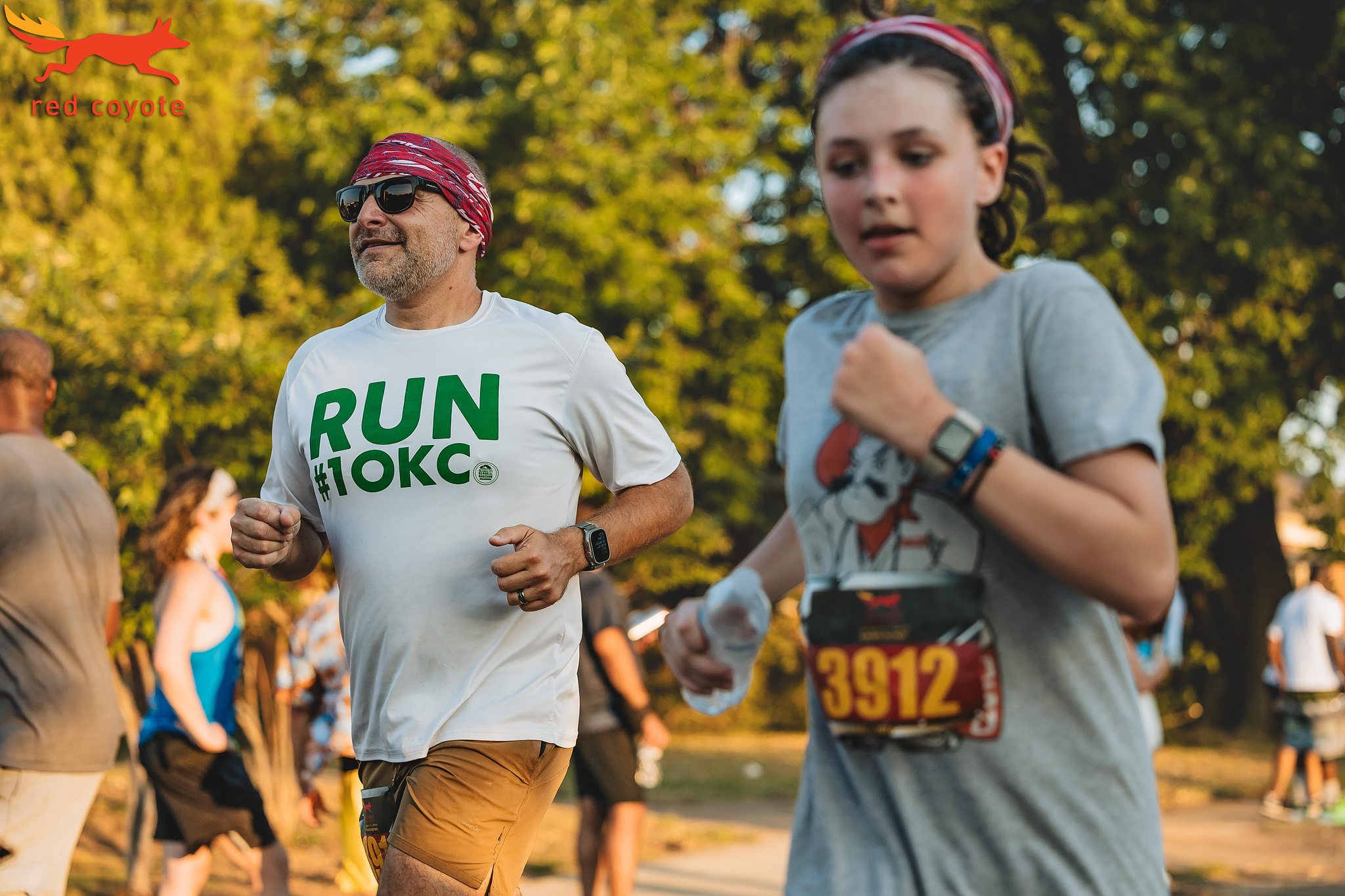 A dad and his daughter running.