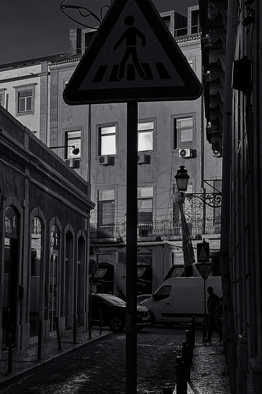 A messy street view, with buildings, cars, people, traffic signals,...