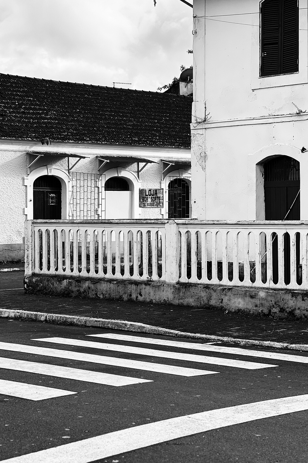 A crosswalk, with buildings. 