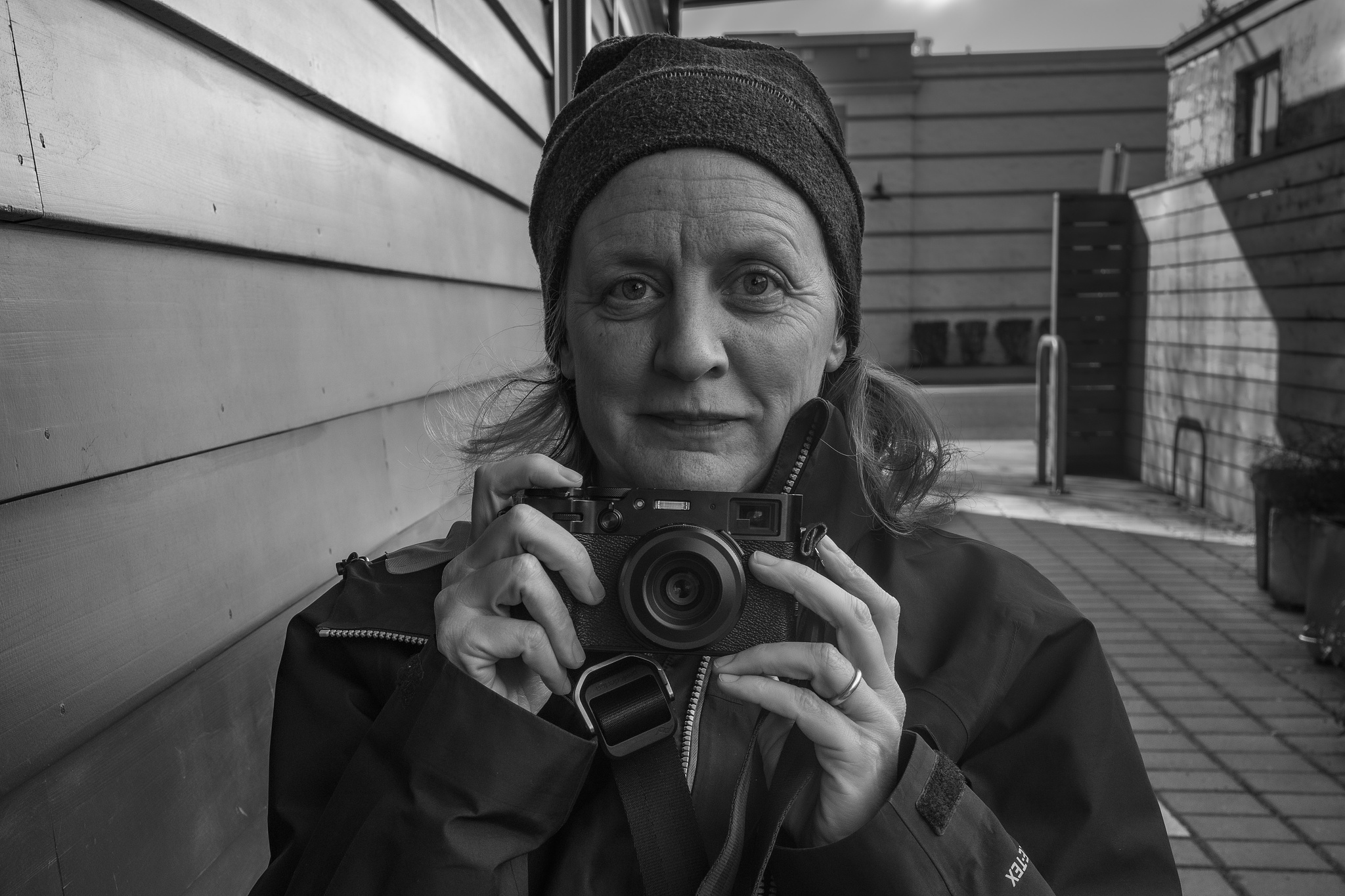 A woman looking over the top of a rangefinder camera