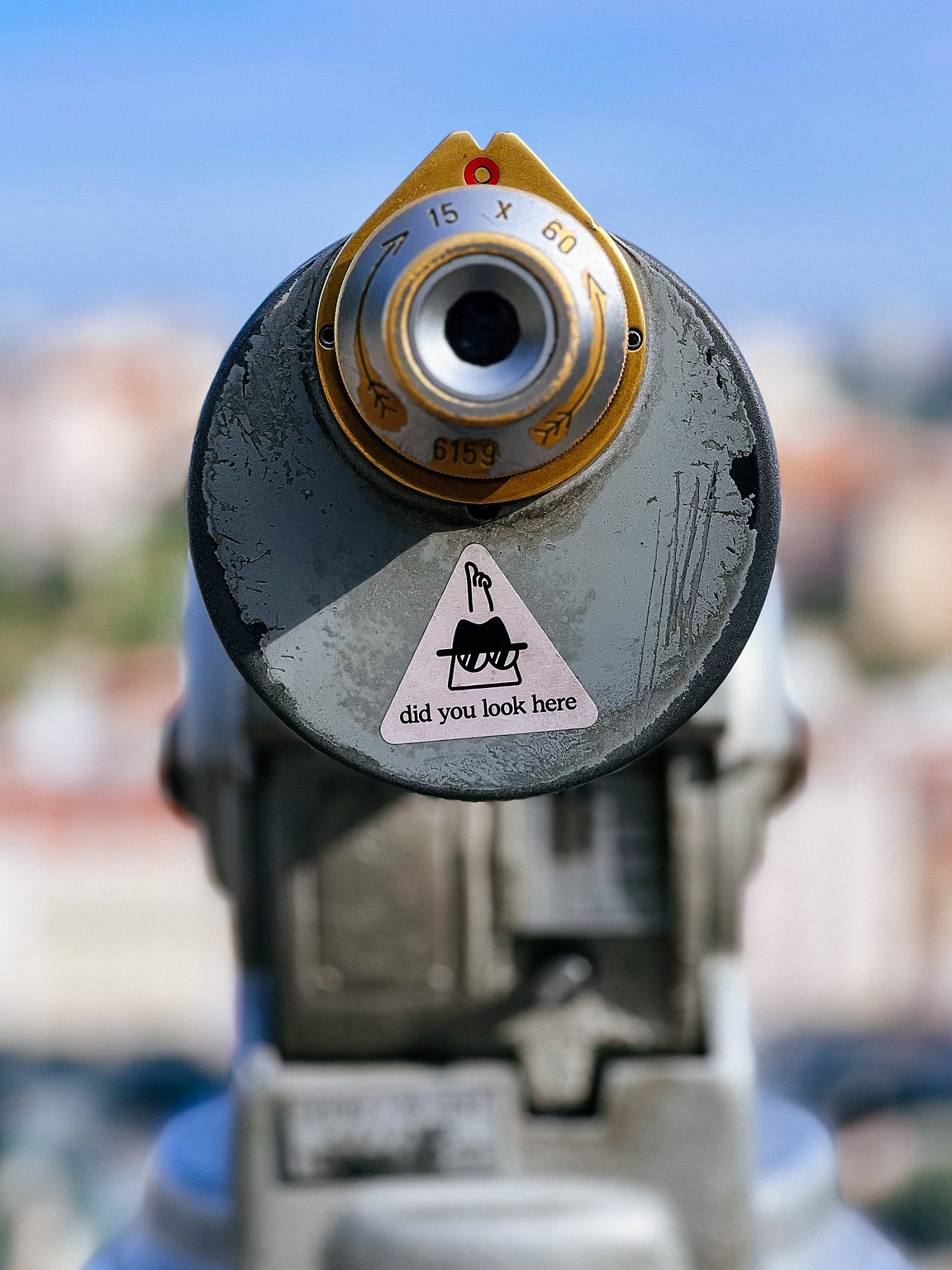 A sticker with "did you look here?" written on it, and a hand pointing at a viewfinder.