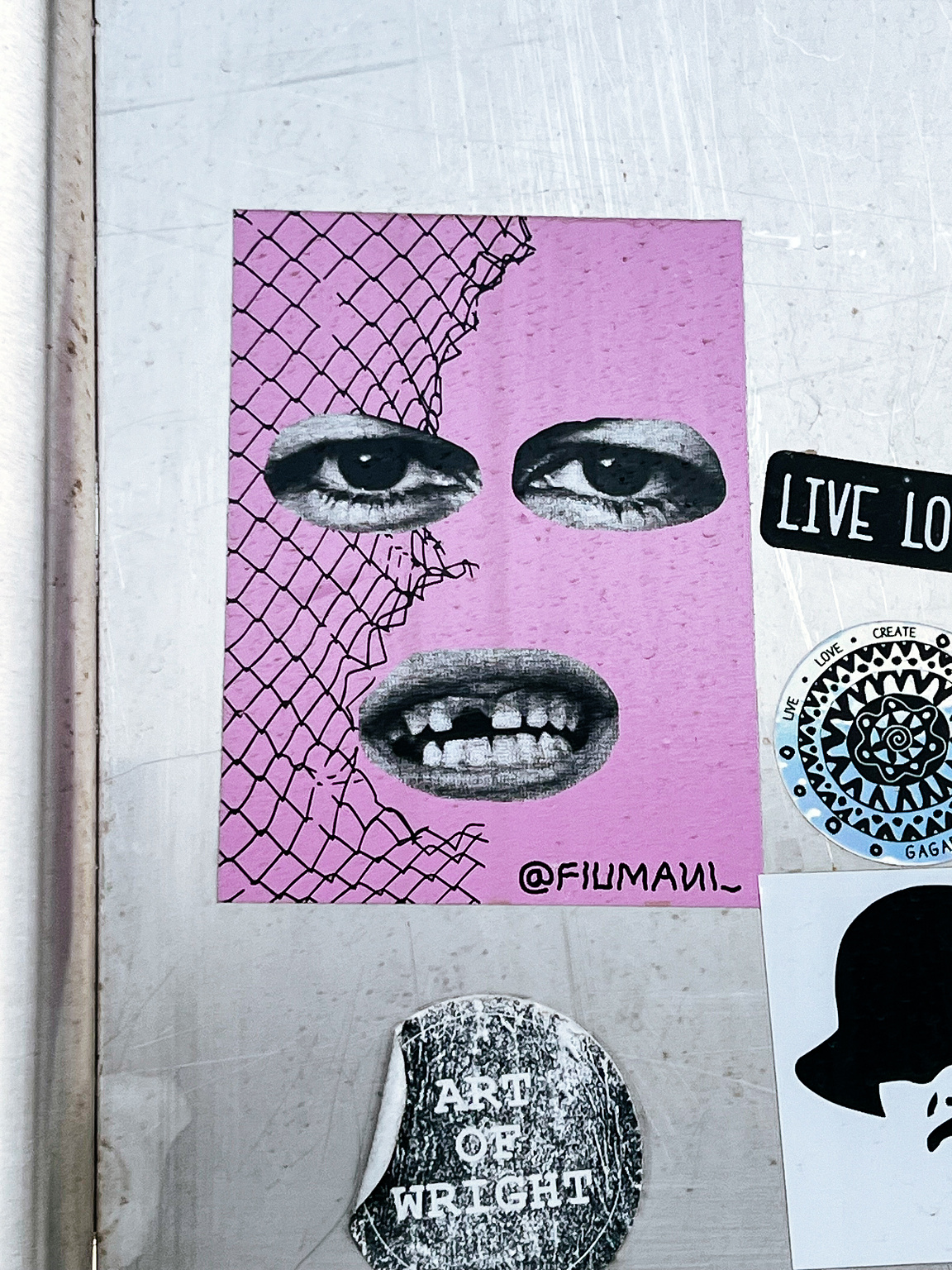 Collage with two eyes, a mouth with a missing tooth, and a fence. Pink background. 