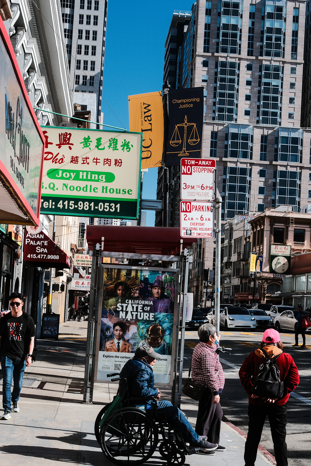 People waiting at a bus stop in Chinatown