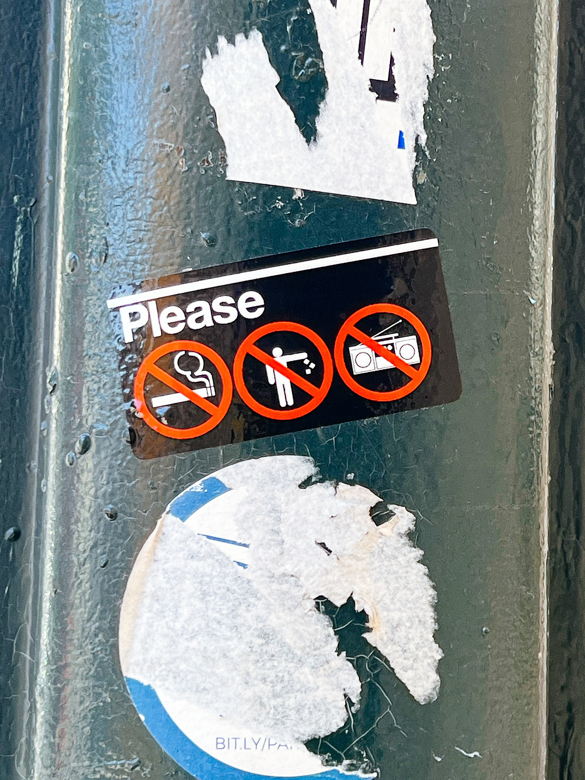 Sticker asking people to refrain from smoking, littering, and playing loud music. 