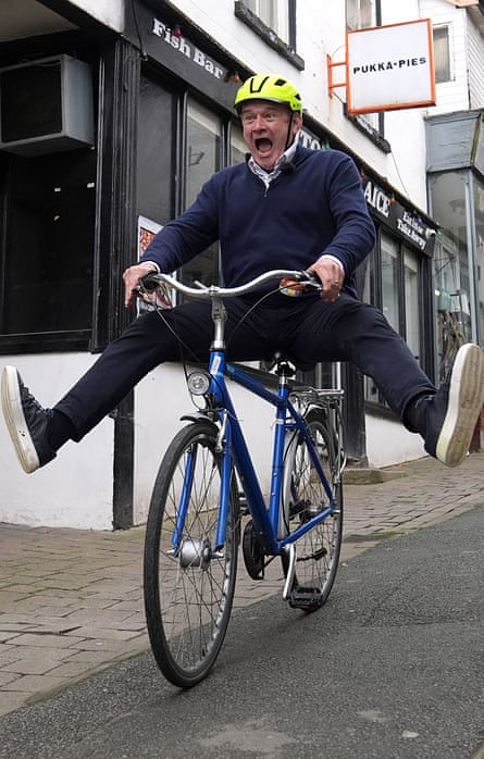 Ed Davey riding a bike down a hill