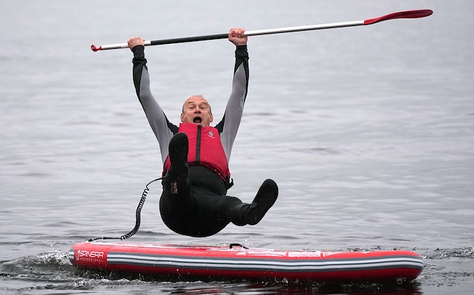 Ed Davey falling off a paddle board with a great expression