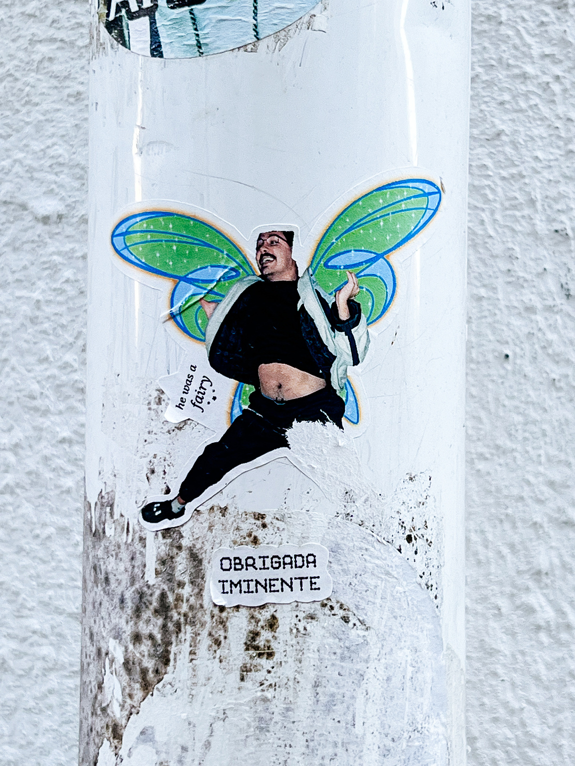 A man, jumping, with fairy wings. 