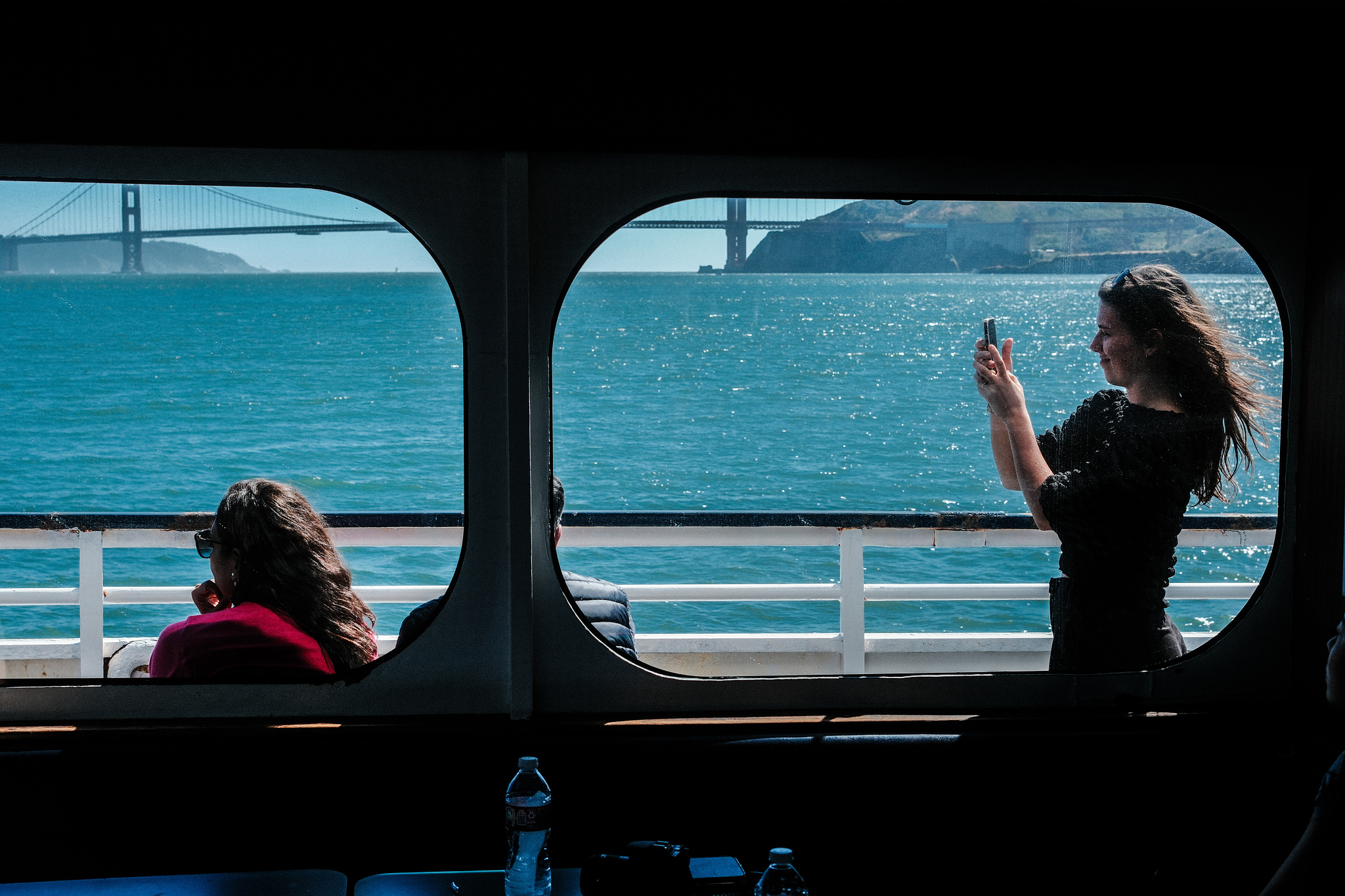 A young woman on a tour boat takes a selfie