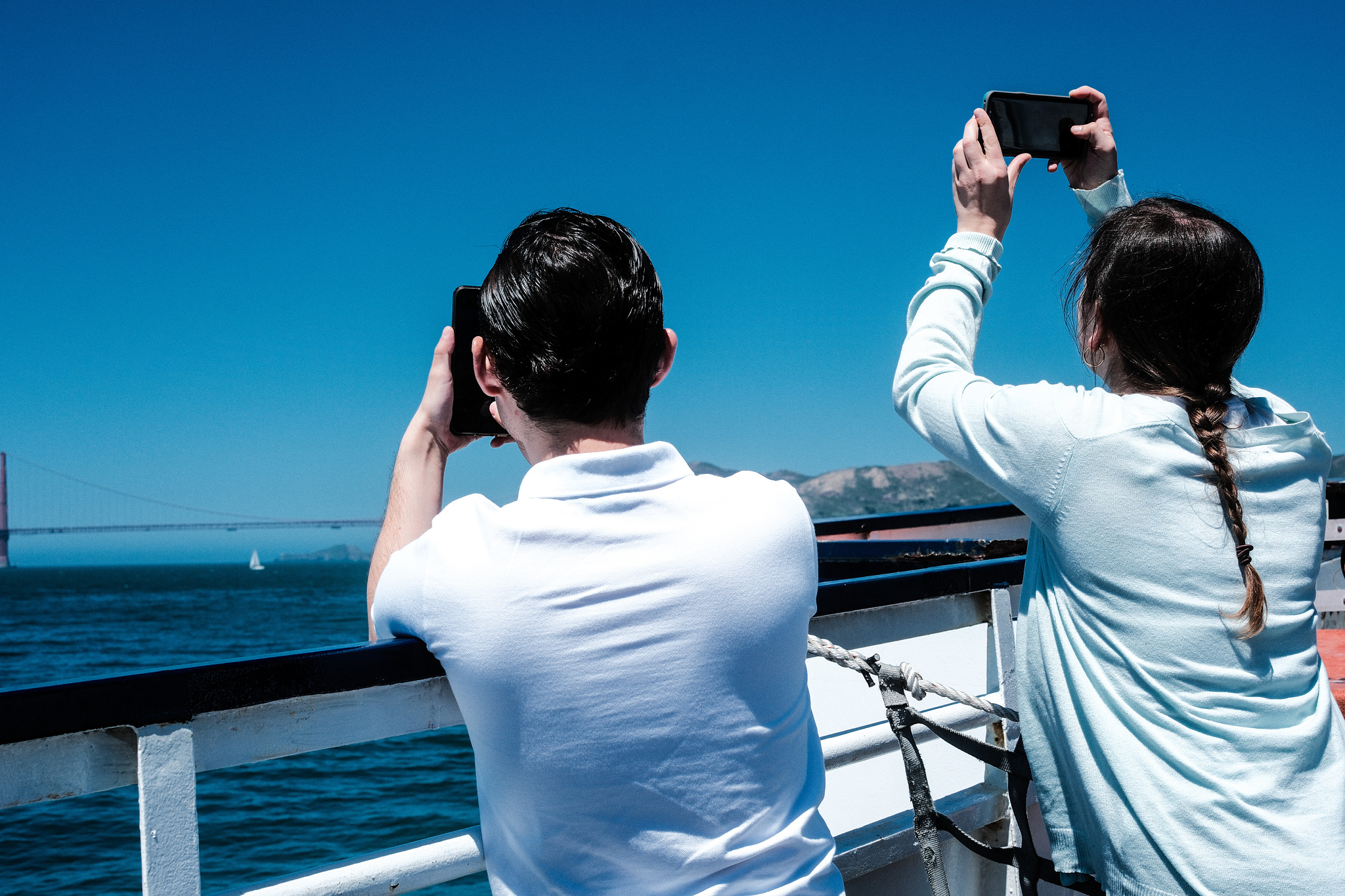 People on a tour boat taking pictures with their phones