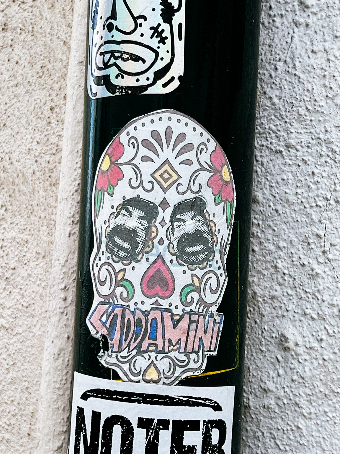 A mexican style skull, with Saddam's faces for eyes. 