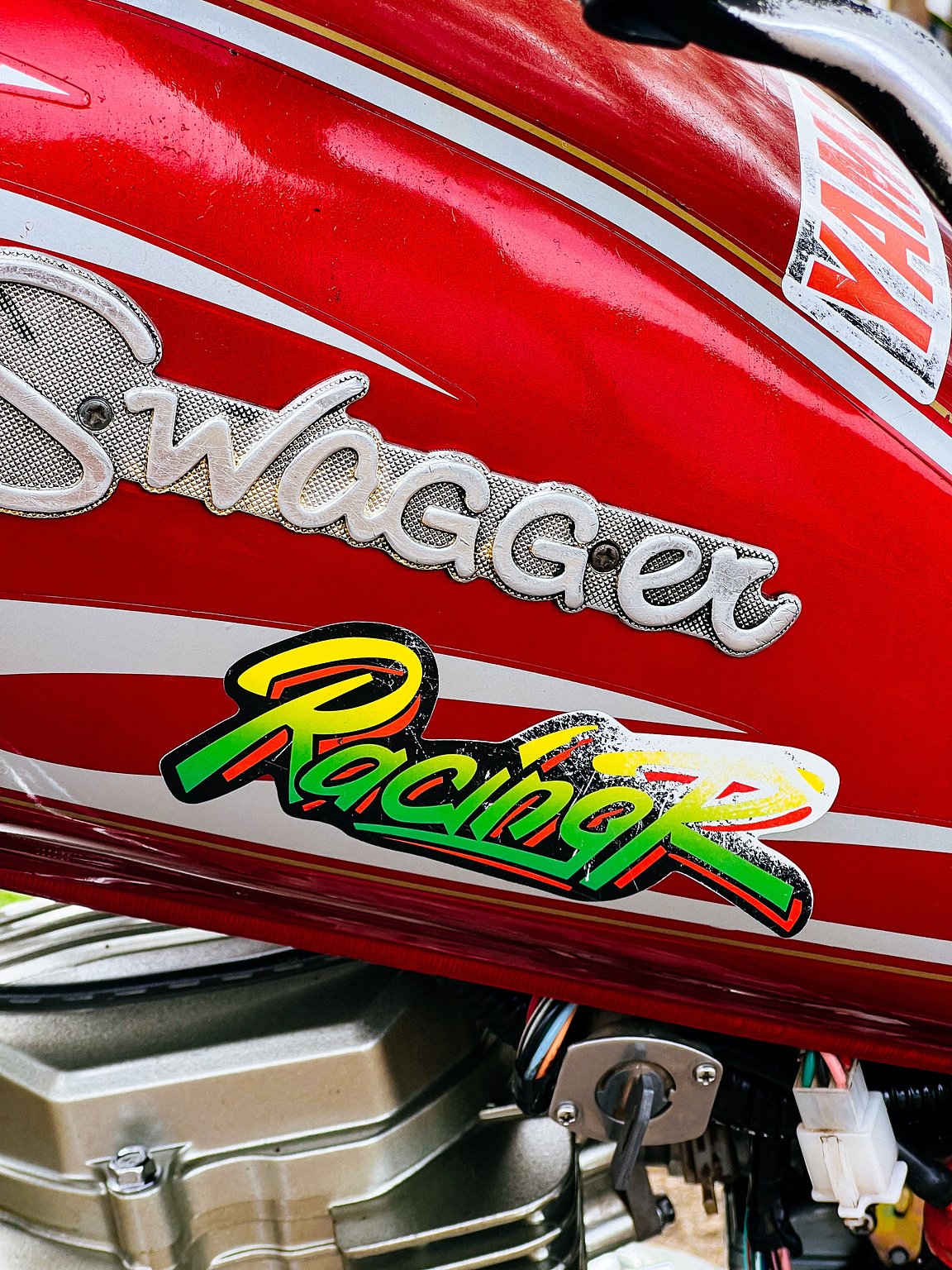 "Racing" sticker on a motorcycle's gas tank. 