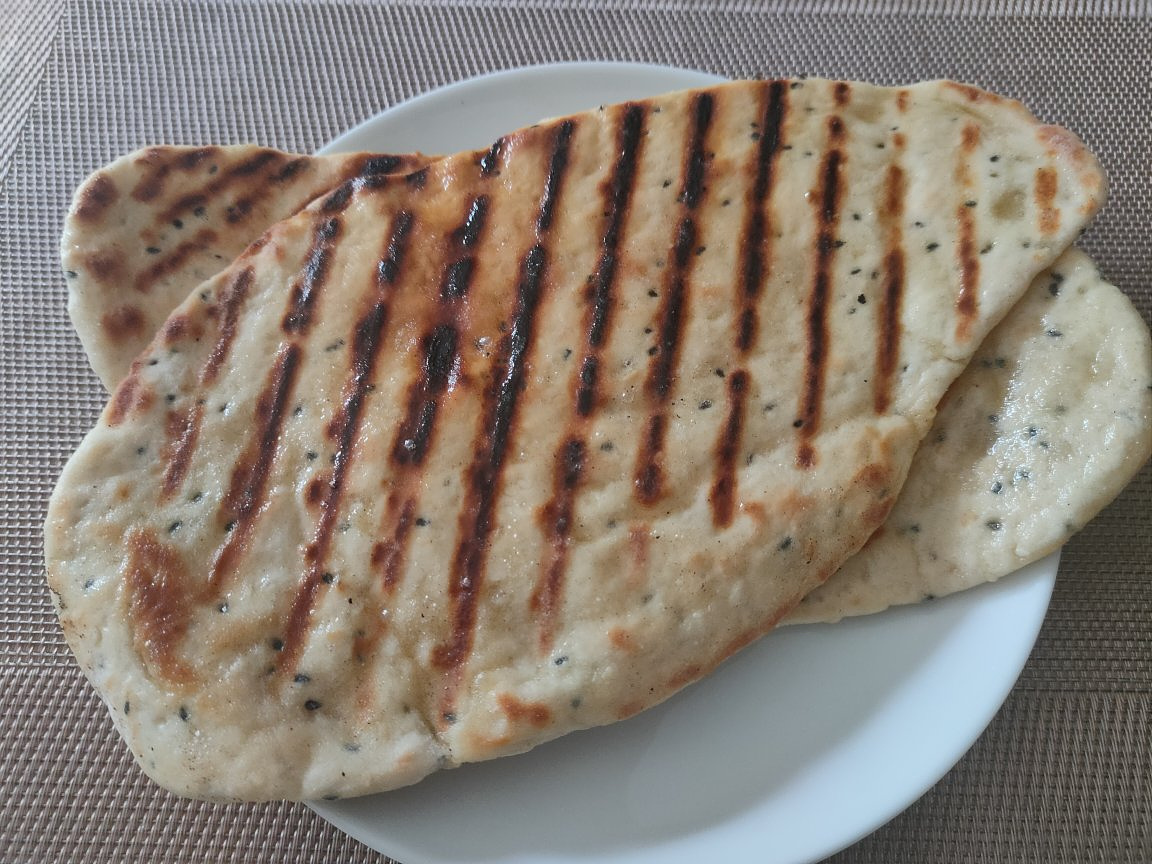 A photo of two white flat breads sitting on a plate