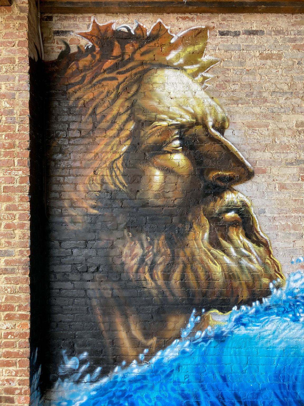 Poseidon mural on the patio of Kudzu Seafood in downtown Macon.