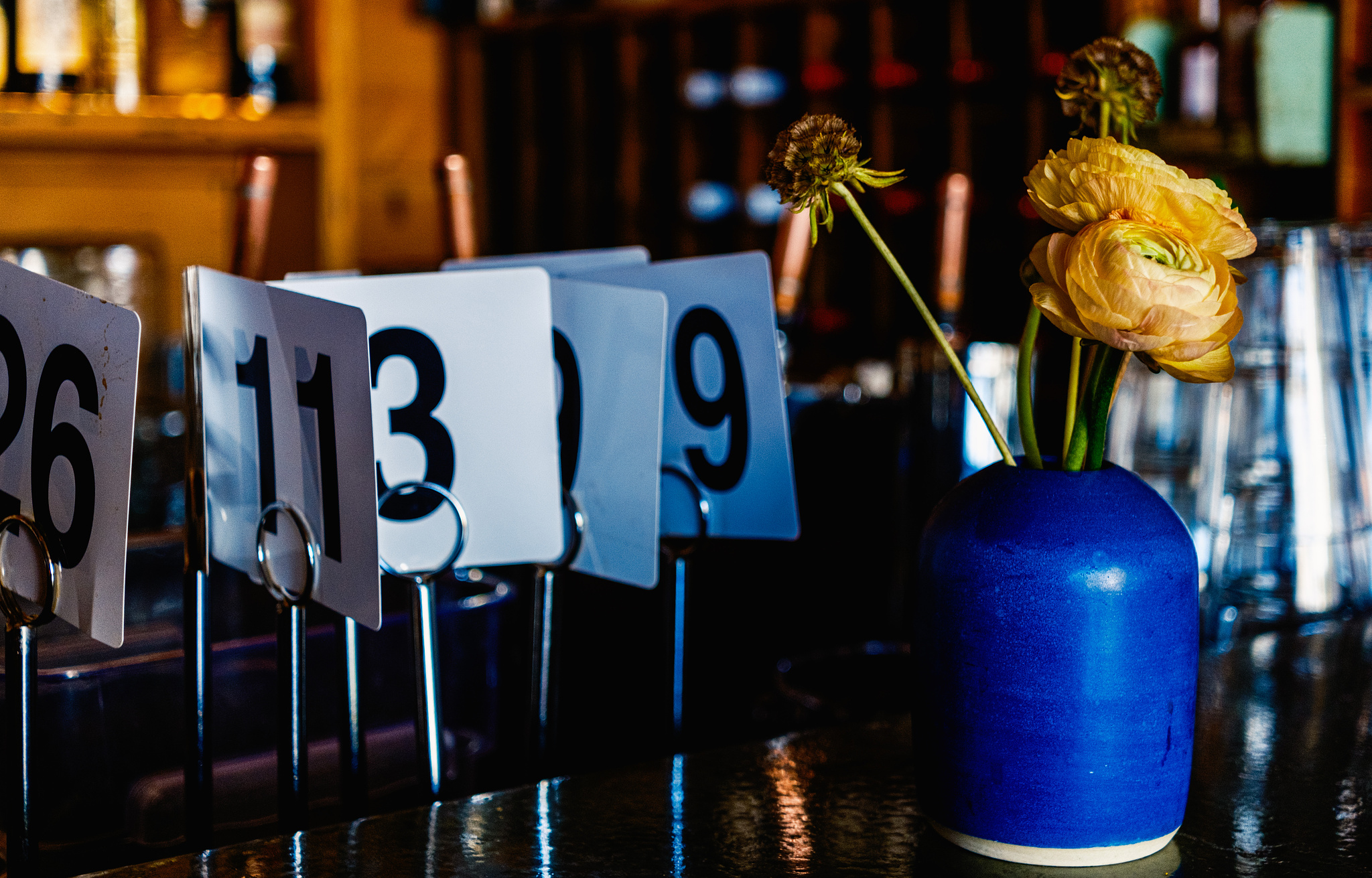 Yellow flowers in a blue vase at Bye and Bye