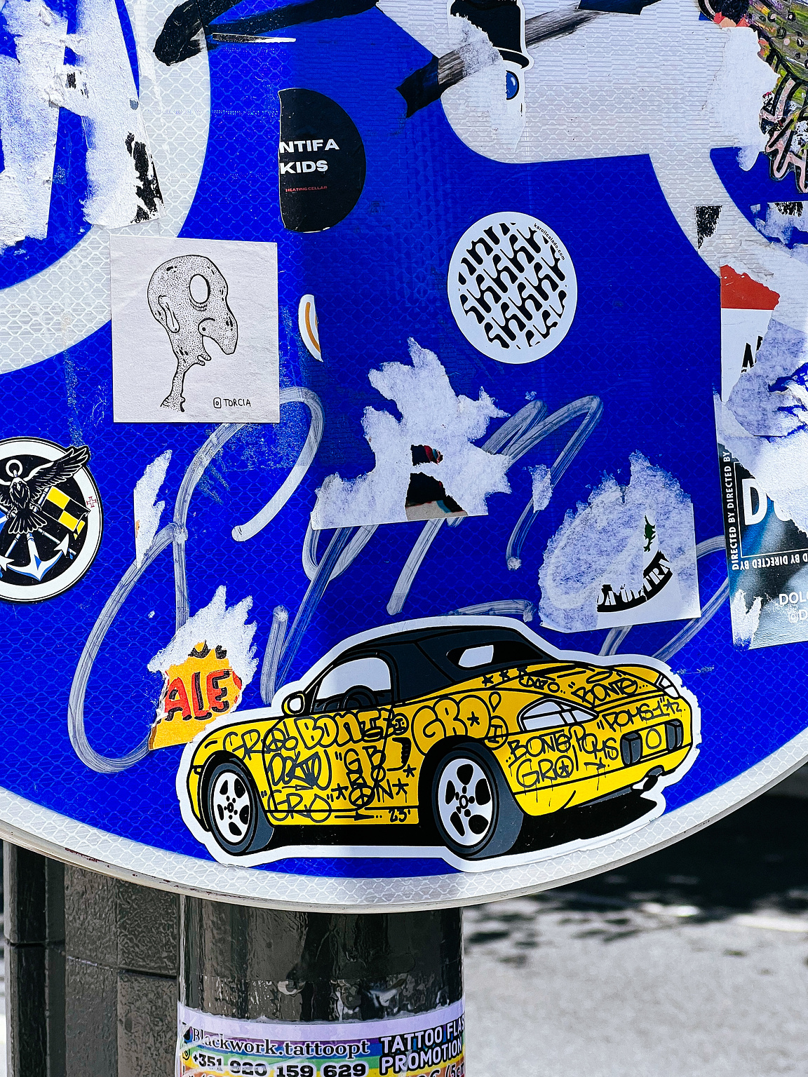 A sticker with a graffitied yellow car. 