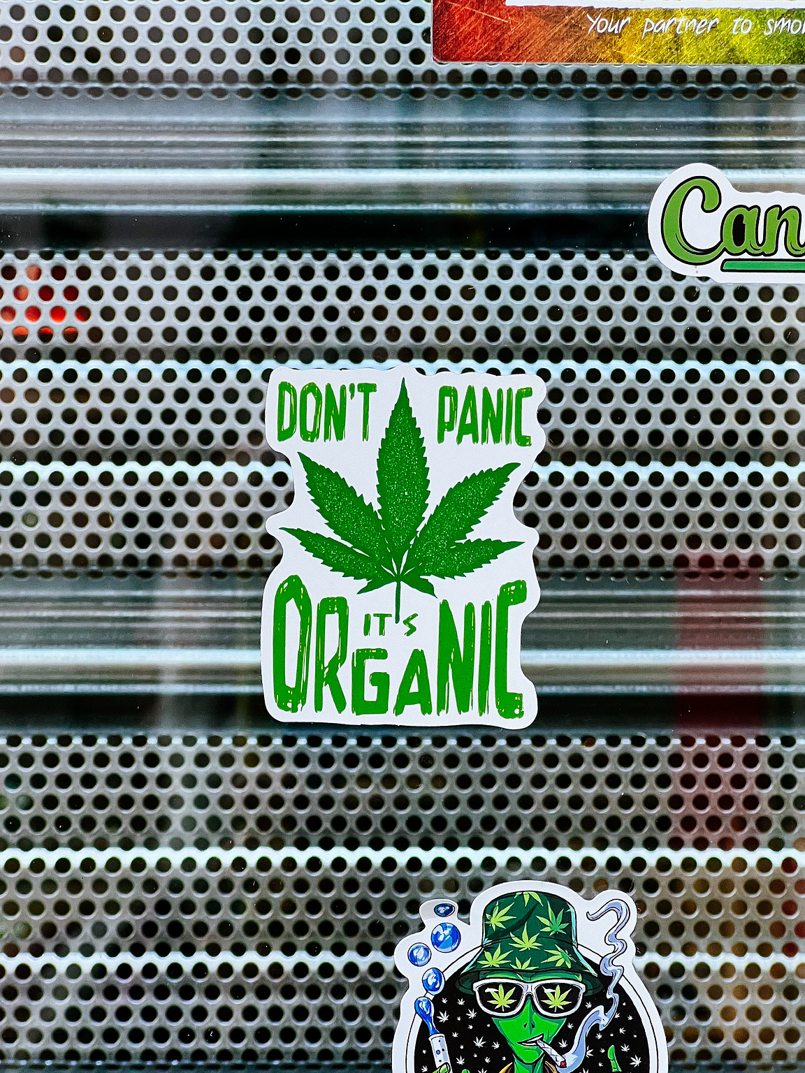 "Don't panic, it's organic" and and marijuana leaf. 