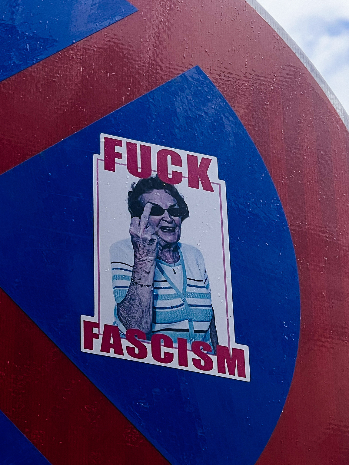 "Fuck Fascism", and a photo of an older woman showing us the finger. 