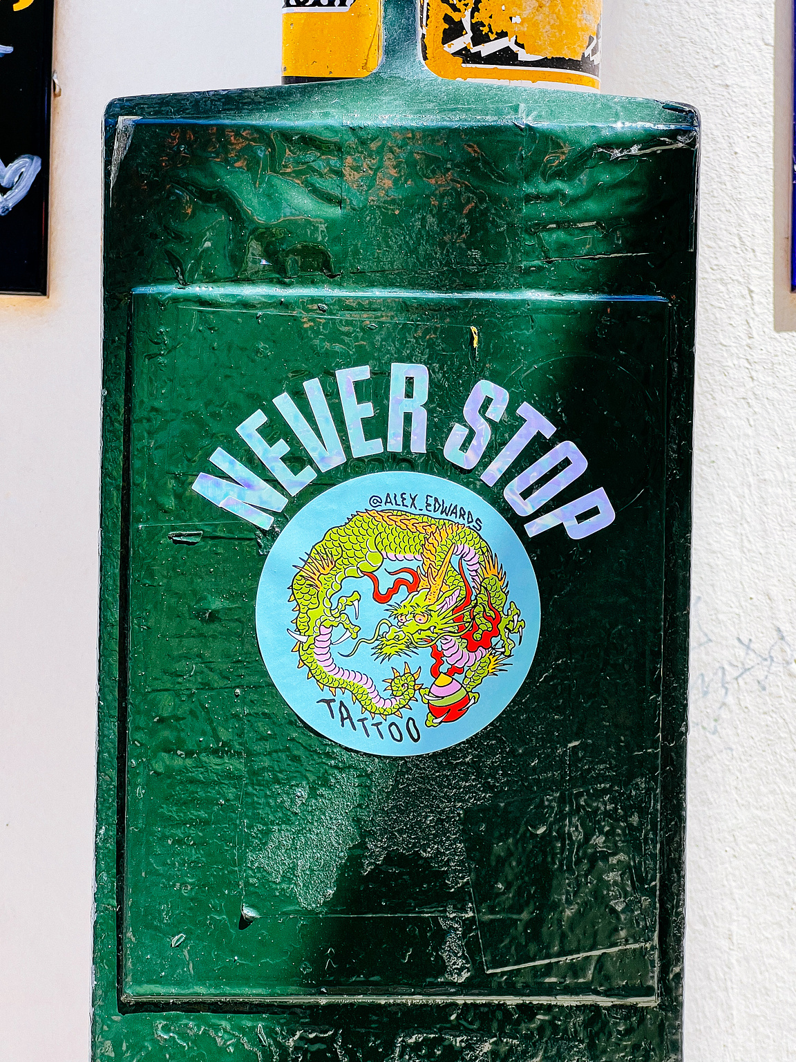 "Never stop", and a dragon tattoo. 