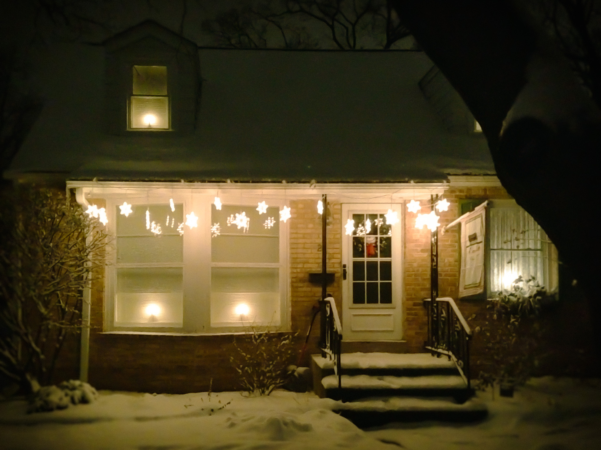 House lit with Christmas decorations at night