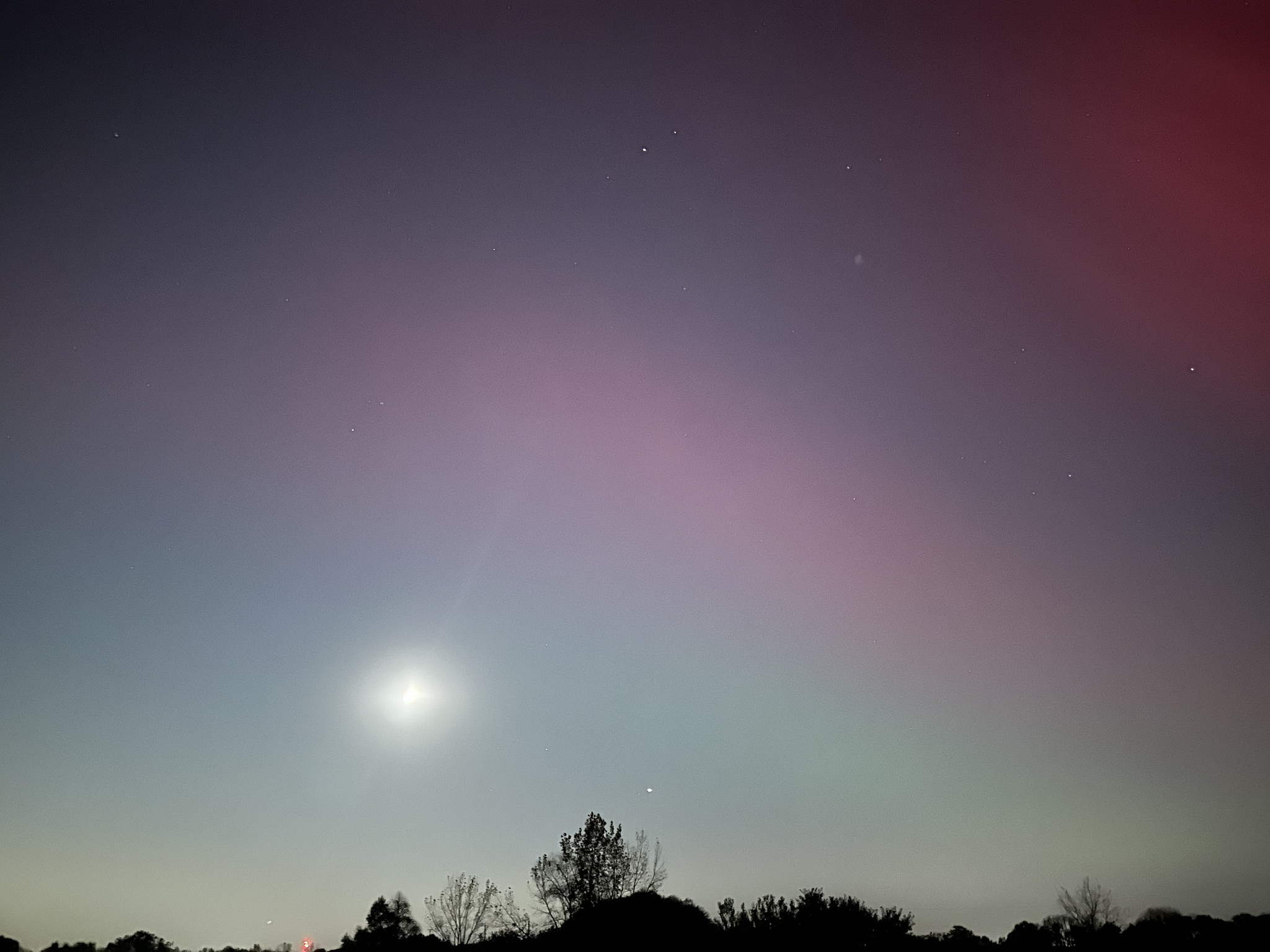 The moon and stars with multi-colored Northern Lights