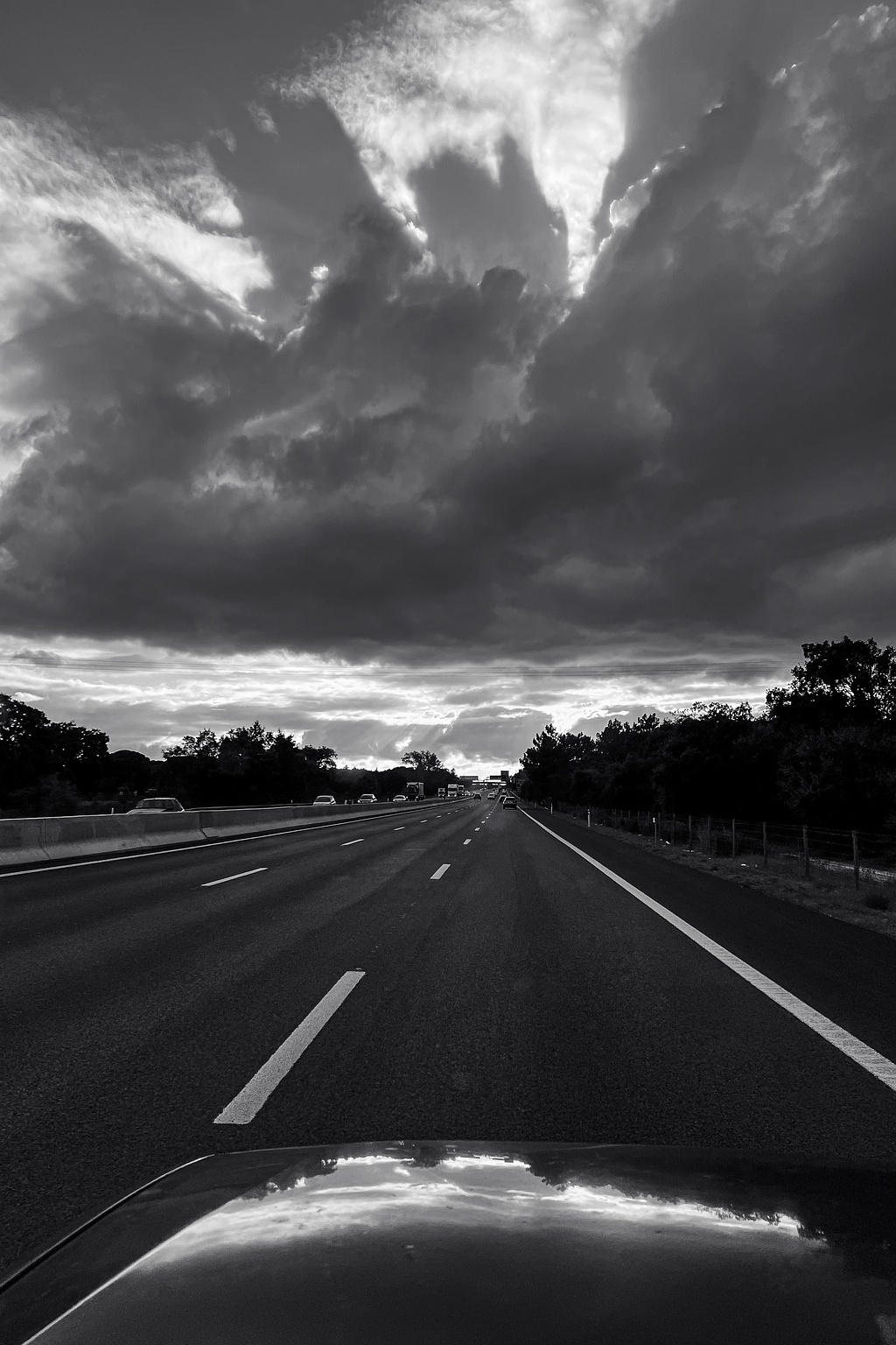 A road, cloudy skies.