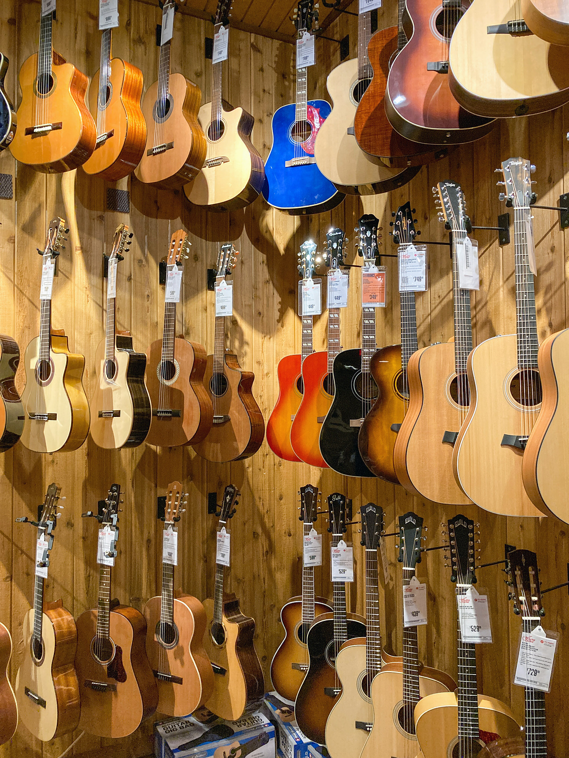 Rows of acoustic guitars on display at Guitar Center.