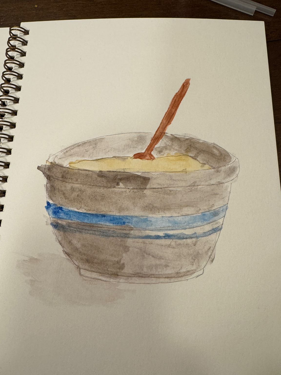 watercolor painting of a mixing bowl, wooden spoon, and batter