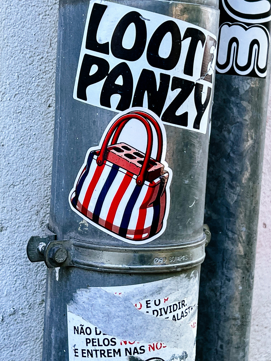 A handbag with a brick inside. A sticker. 