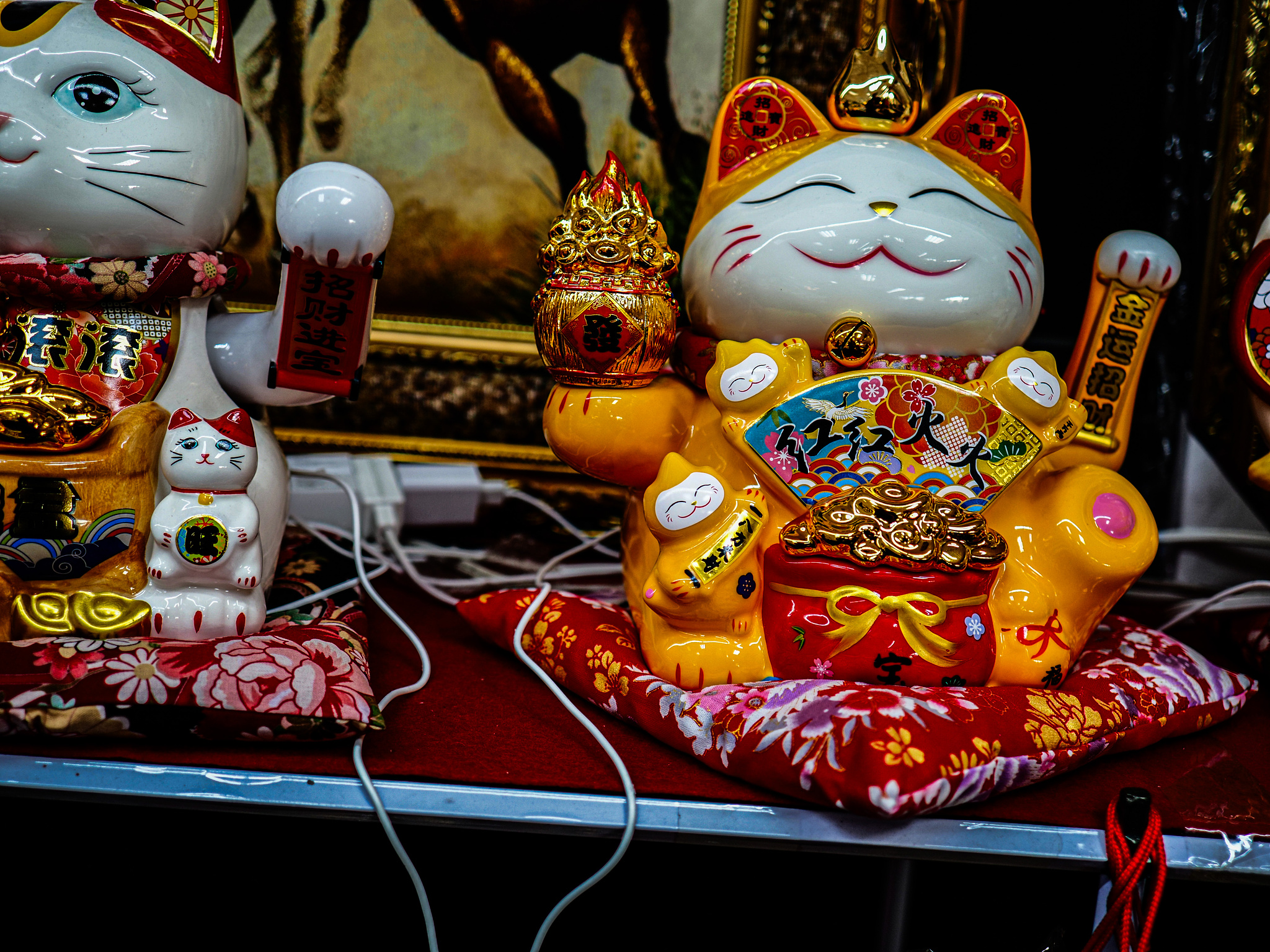 A colorful golden Maneki Neko on a shelf. 