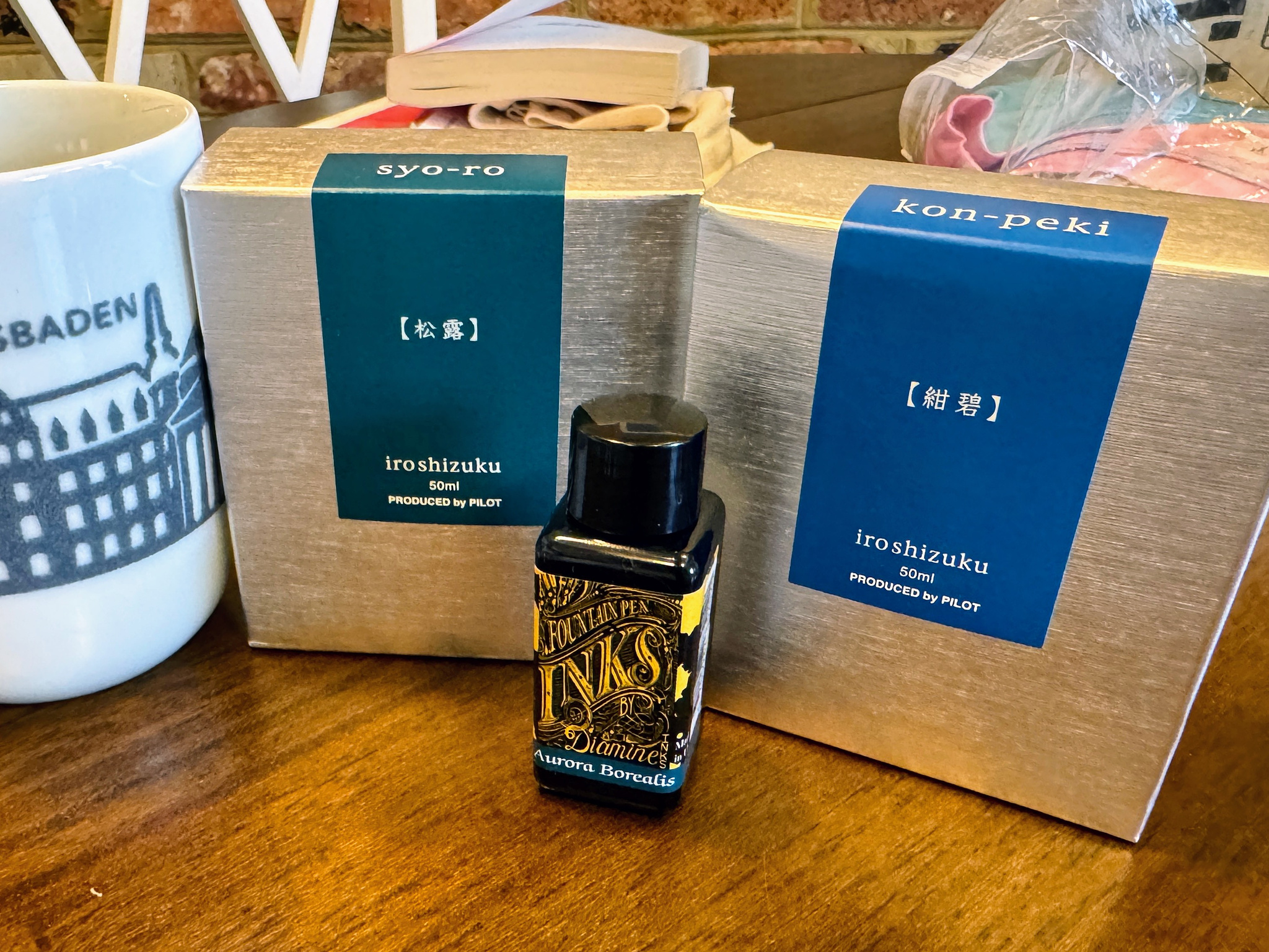 Two boxes and one vial of fountain pen ink