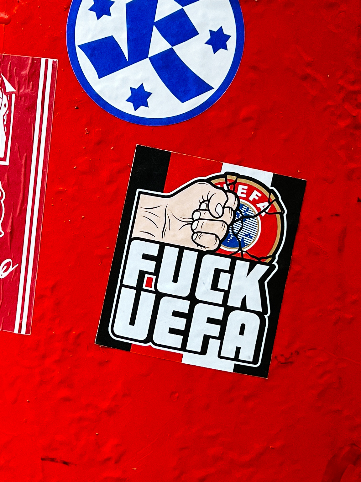 A hand punching a UEFA logo, and the message "Fuck UEFA" next to it. 