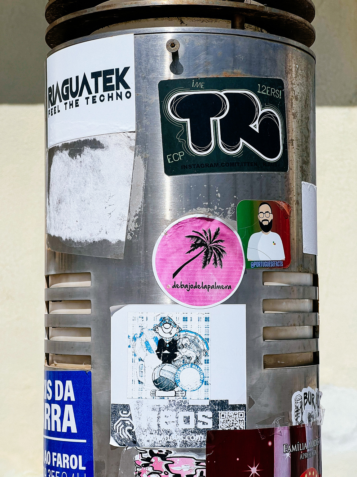 Multiple stickers, including a pink one with a palm tree.