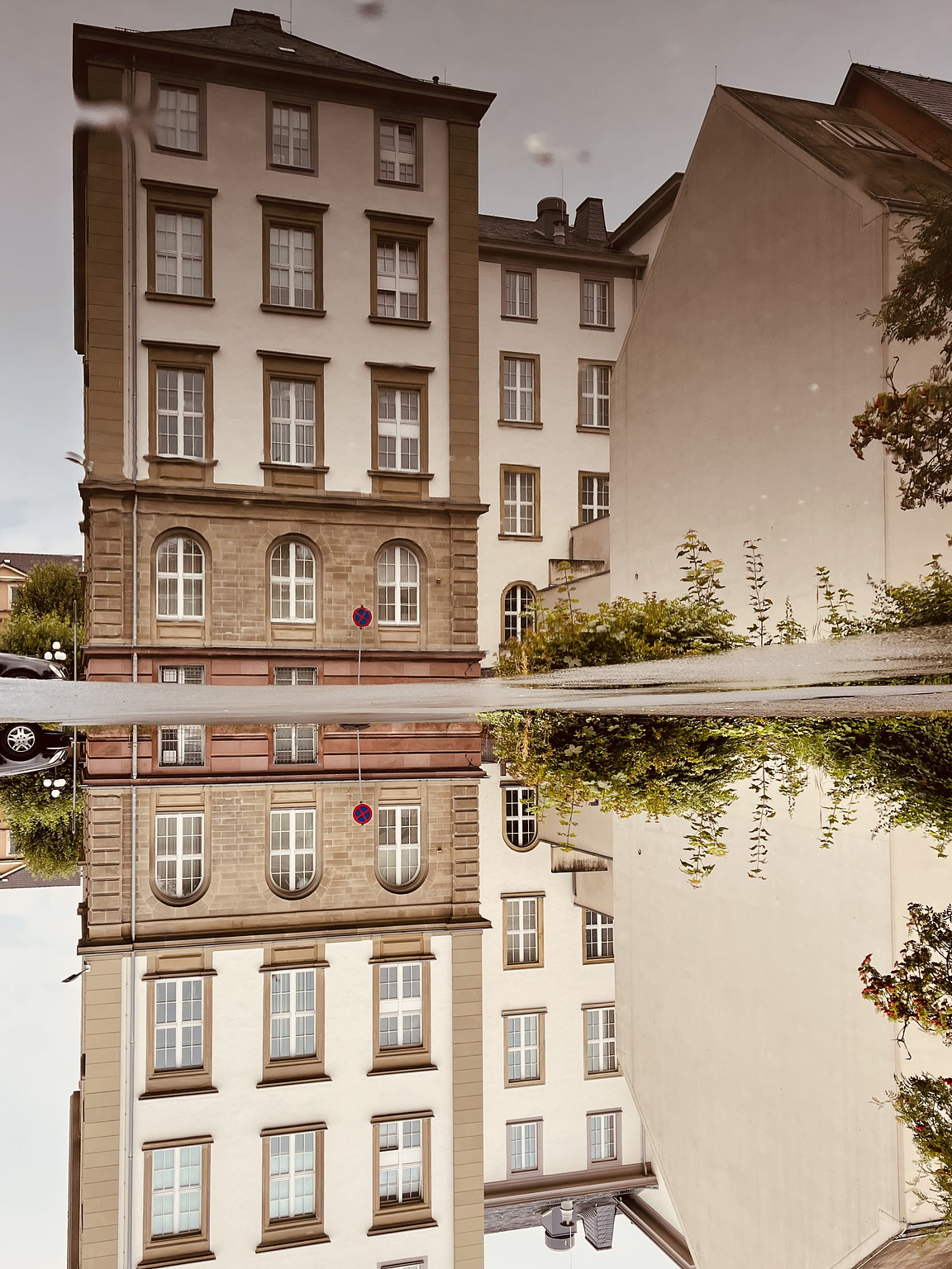 Historic building, reflected in a puddle. The picture is turned upsidedown.