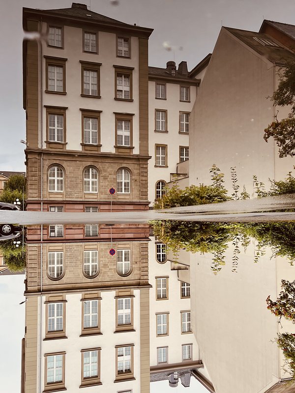 Historic building, reflected in a puddle. The picture is turned upsidedown.