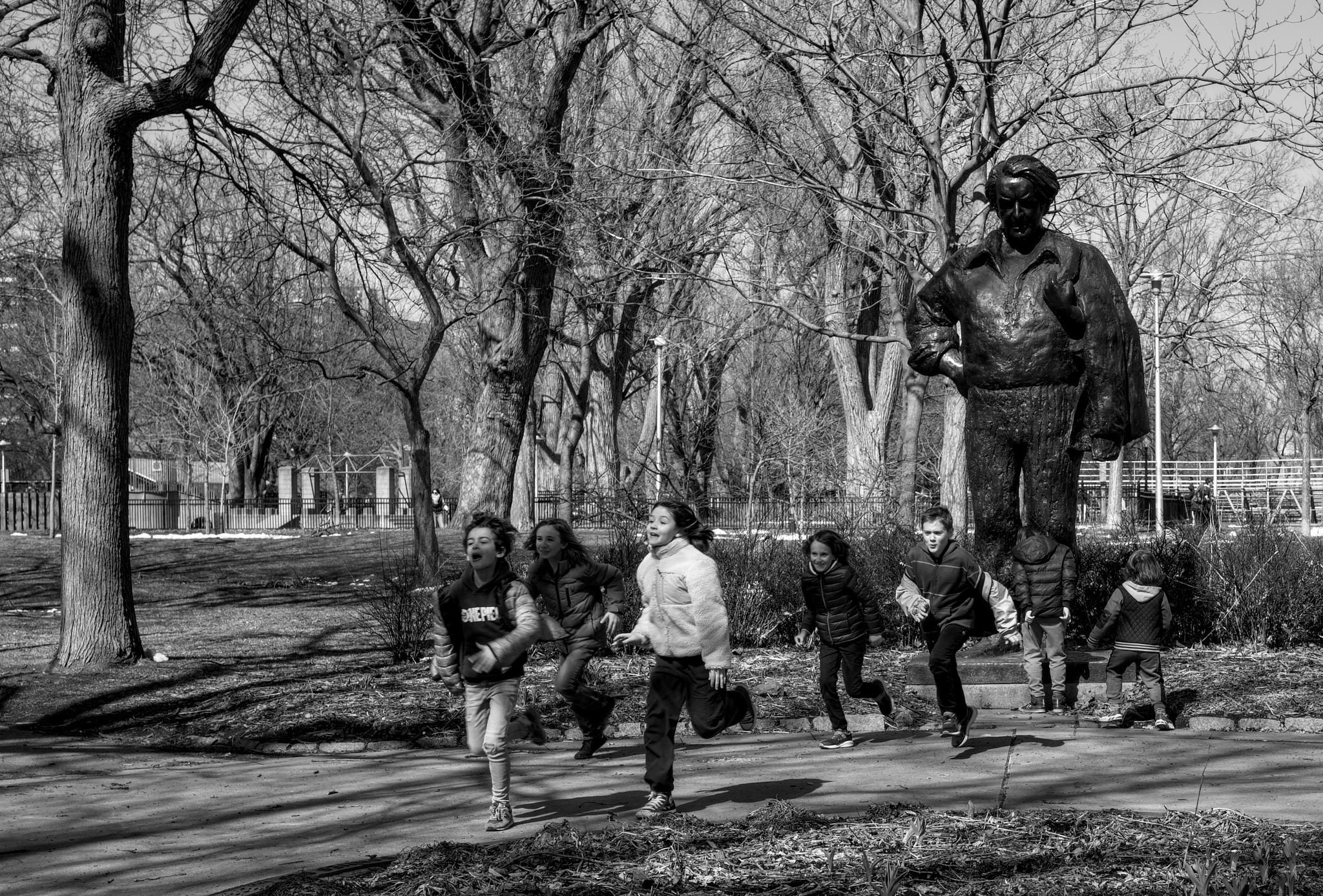 Kids playing around a statue