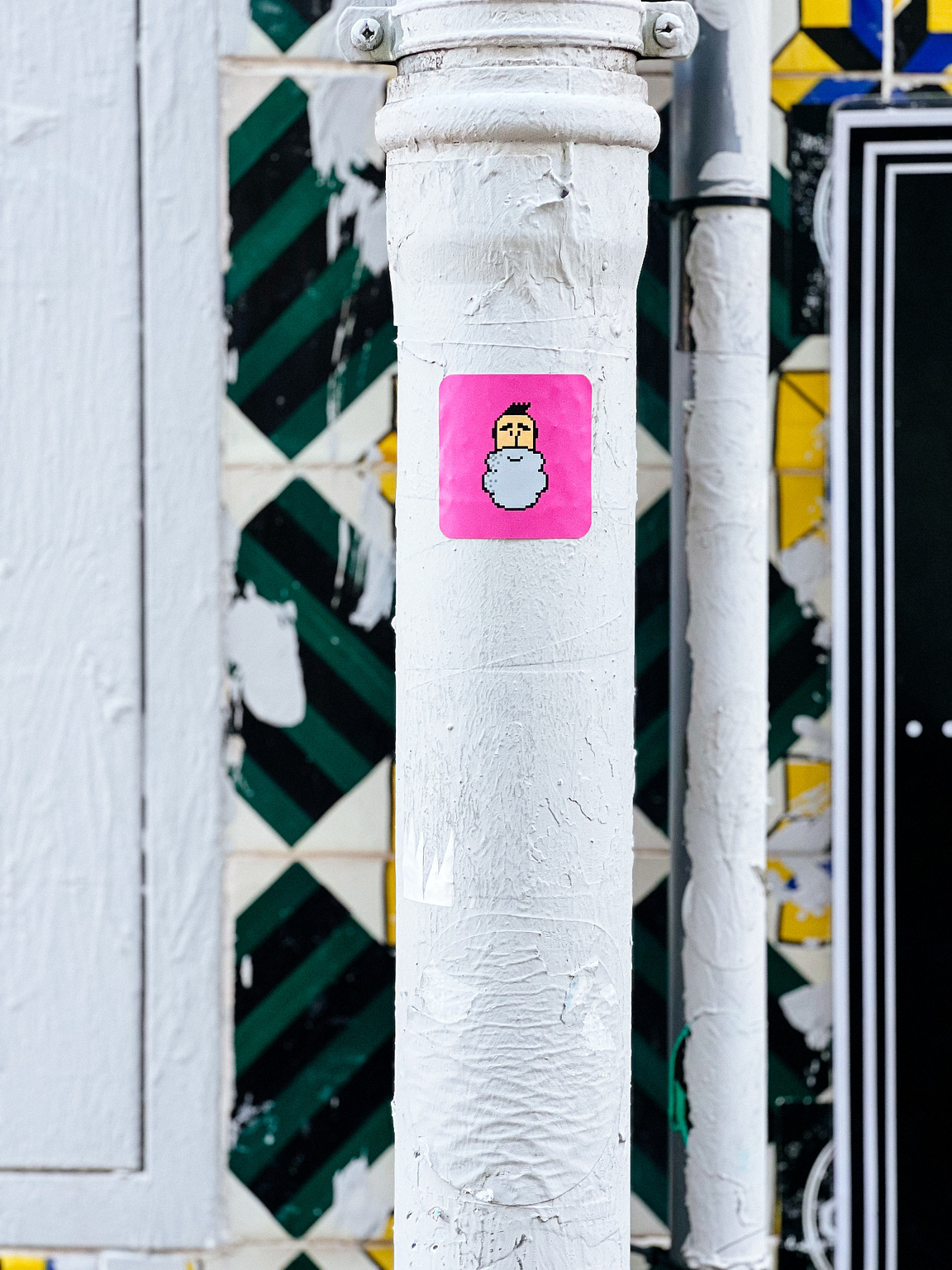 Sticker of a pixelated bearded man.