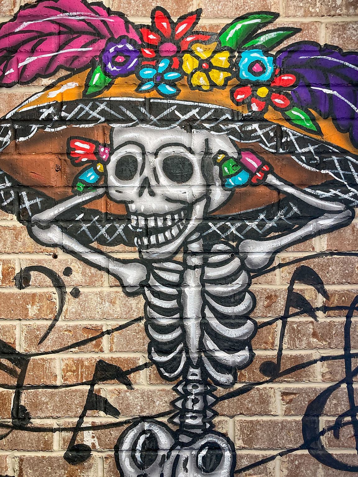 Skeleton mural on a brick wall inside Pedro’s Tacos & Tequila Bar.