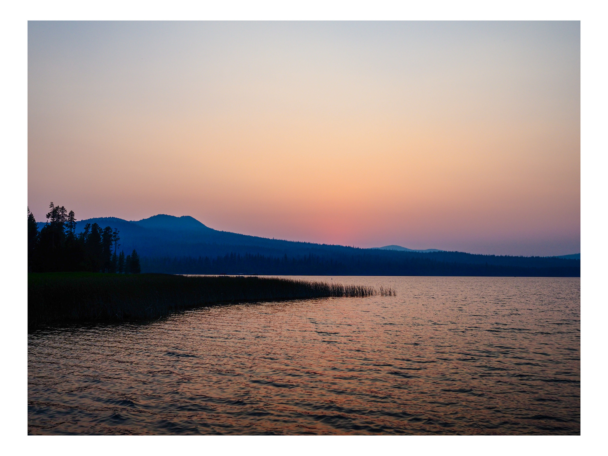 Hazy, muted  sunset over a Central Oregon lake