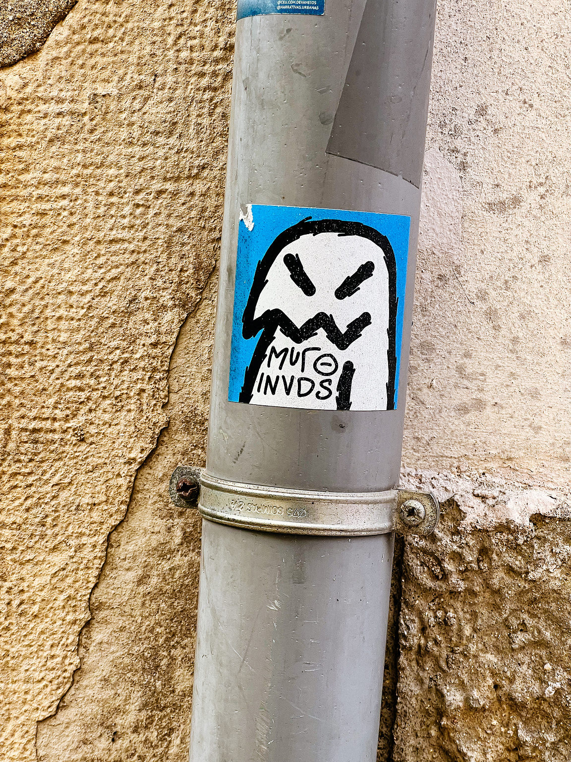 A sticker with a ghost-like character. 