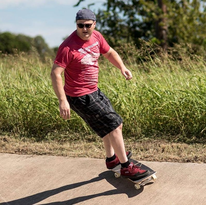 man skateboarding in a ditch